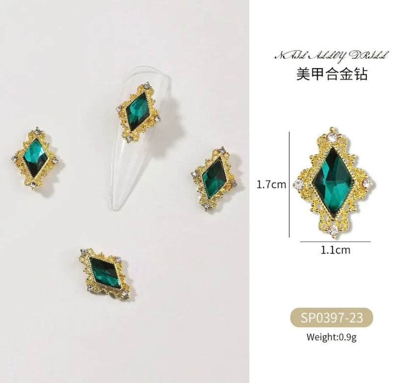 A set of Zircon Variety Charms earrings from Luxenailhaven, made with emerald and gold studs.